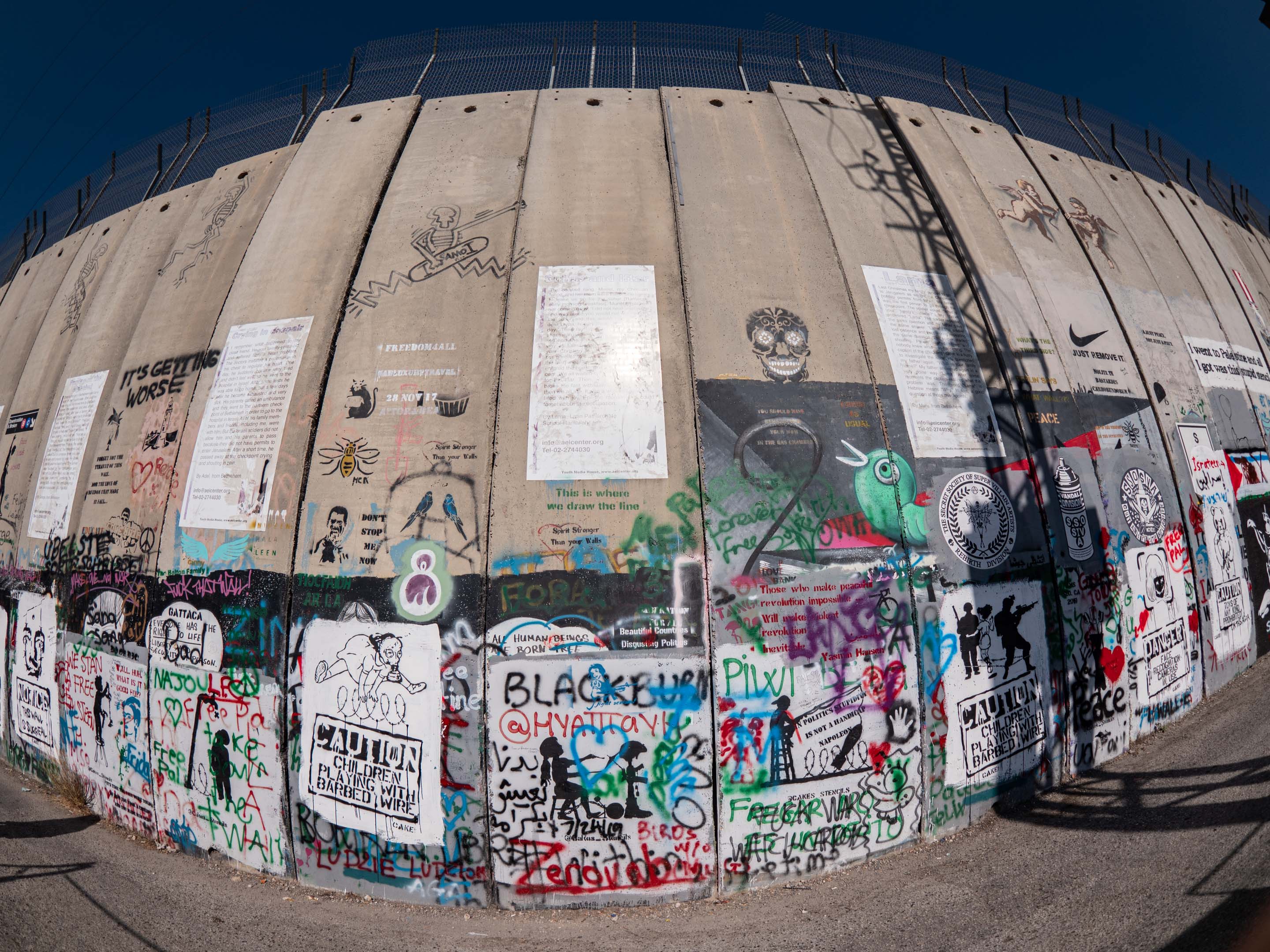 In 2005 street artist Banksy painted nine art works on the wall. Locals started to copy the motives and did their own writings and drawings. Also, international artists started to visit Bethlehem and eternize themselves on the eight meters high wall. The Israeli West Bank barrier now is a popular spot for graffiti artists expressing their political messages.